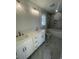 Bathroom features a double sink vanity, modern fixtures, and a tiled shower at 2309 Seaseeker Ln., Myrtle Beach, SC 29577