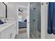 Bright bathroom featuring tiled shower with glass door, white vanity, and bedroom view at 2309 Seaseeker Ln., Myrtle Beach, SC 29577