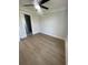 Bedroom with a ceiling fan, neutral paint, and wood-look flooring leading to an en suite bathroom at 2309 Seaseeker Ln., Myrtle Beach, SC 29577