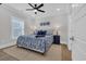 Well-lit bedroom boasts modern decor with white trim, a ceiling fan, and a large window at 2309 Seaseeker Ln., Myrtle Beach, SC 29577