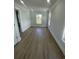 Well-lit room with neutral walls, modern trim, light wood floors, and natural light from two windows at 2309 Seaseeker Ln., Myrtle Beach, SC 29577