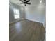 A bedroom featuring light wood floors, a large window, and neutral-colored walls at 2309 Seaseeker Ln., Myrtle Beach, SC 29577