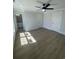 Large bedroom features wood floors, modern ceiling fan, and access to a bathroom at 2309 Seaseeker Ln., Myrtle Beach, SC 29577