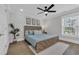 Calm bedroom with a wood-framed bed, soft lighting, and a large window at 2309 Seaseeker Ln., Myrtle Beach, SC 29577