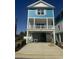 New construction home with blue siding, white trim, and a spacious covered parking area at 2309 Seaseeker Ln., Myrtle Beach, SC 29577