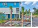 Charming coastal home with blue siding, palm trees, and close beach access at 2309 Seaseeker Ln., Myrtle Beach, SC 29577