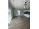 Bright living room with modern ceiling fan, light wood floors, and sliding door access to outdoor porch at 2309 Seaseeker Ln., Myrtle Beach, SC 29577