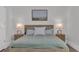 Nicely decorated main bedroom features a wood bed frame, patterned rug, lamps, and art at 2309 Seaseeker Ln., Myrtle Beach, SC 29577
