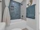 Tub and shower combination featuring stylish blue tiled walls and recessed niche at 2309 Seaseeker Ln., Myrtle Beach, SC 29577