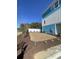 Landscaped yard with mulch and grass featuring modern blue and white siding at 2309 Seaseeker Ln., Myrtle Beach, SC 29577