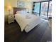 Bedroom with comfortable bedding, nightstands, lamps, and balcony access at 2311 S Ocean Blvd. # 144, Myrtle Beach, SC 29577