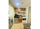 A compact kitchenette featuring modern appliances and storage at 2311 S Ocean Blvd. # 144, Myrtle Beach, SC 29577