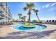 Scenic outdoor pool surrounded by palm trees, next to lounge chairs and hotel at 2311 S Ocean Blvd. # 144, Myrtle Beach, SC 29577