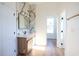 Well-lit bathroom featuring marble accent wall, wood vanity, and modern fixtures at 232 Ole Maple St., Loris, SC 29569