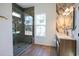 Modern bathroom featuring a glass shower, pebble floor, granite walls, and light wood vanity at 232 Ole Maple St., Loris, SC 29569