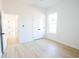 Sunlit bedroom with light wood-look floors, a window, and double-door closet at 232 Ole Maple St., Loris, SC 29569