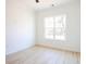 Bright, naturally lit bedroom with hardwood flooring and a large window at 232 Ole Maple St., Loris, SC 29569