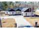 A charming single-story home featuring a concrete driveway and a mix of brick and wood accents at 232 Ole Maple St., Loris, SC 29569