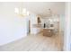 Open-concept kitchen with white cabinets, a center island, and modern pendant lighting at 232 Ole Maple St., Loris, SC 29569
