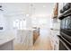 Modern kitchen with white countertops, wood floors, and a stylish center island with seating at 232 Ole Maple St., Loris, SC 29569