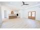 Open-concept living area with wood floors, a ceiling fan, and a view into the adjacent kitchen at 232 Ole Maple St., Loris, SC 29569