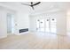 Bright living room featuring modern floors, a tray ceiling, a ceiling fan and sliding glass doors at 232 Ole Maple St., Loris, SC 29569