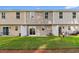 View of a townhome backyard with a sliding glass door, white fence, and well-maintained lawn at 247 Christiana Ln. # D, Myrtle Beach, SC 29579