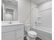 Well-lit bathroom showcasing a sleek white vanity, toilet, and shower-tub combo at 247 Christiana Ln. # D, Myrtle Beach, SC 29579