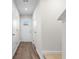 Hallway with wood flooring, white walls, and an exterior door at the end at 247 Christiana Ln. # D, Myrtle Beach, SC 29579