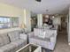 Living room with comfortable seating and view into kitchen/dining area at 2507 S Ocean Blvd., North Myrtle Beach, SC 29582