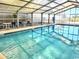 Enclosed pool area with clear blue water and comfortable seating under a translucent roof at 2507 S Ocean Blvd., North Myrtle Beach, SC 29582