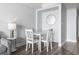 Charming dining area with a white table and four chairs, illuminated by a modern lamp at 2600 N Ocean Blvd. # 807, Myrtle Beach, SC 29577