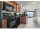 Functional kitchen with modern black appliances, wooden cabinetry, and a pass-through to the living area at 2600 N Ocean Blvd. # 807, Myrtle Beach, SC 29577