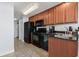 Efficient kitchen with stainless sink, full-sized refrigerator and black appliances, perfect for meal prep at 2600 N Ocean Blvd. # 807, Myrtle Beach, SC 29577
