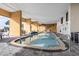 Indoor pool area with tiled deck, lounge chairs, and natural light from adjacent windows at 2600 N Ocean Blvd. # 807, Myrtle Beach, SC 29577