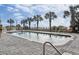 Outdoor swimming pool with lounge chairs and palm trees against a partly cloudy sky at 2600 N Ocean Blvd. # 807, Myrtle Beach, SC 29577