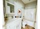 Bright bathroom features a white vanity, wood floor, and a bathtub with a curtain at 2604 Willow St., North Myrtle Beach, SC 29582