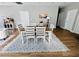 Dining area with a white patterned rug, table with 6 chairs, and grey flooring at 2604 Willow St., North Myrtle Beach, SC 29582