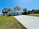 Quaint single-story home displaying an expansive new driveway, blue exterior, and lovely landscaping at 2604 Willow St., North Myrtle Beach, SC 29582