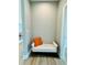Hallway with a small white cushioned bench with an orange pillow and light colored flooring at 2604 Willow St., North Myrtle Beach, SC 29582