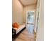 Hallway with a white cushioned bench with an orange pillow, and a water heater room at 2604 Willow St., North Myrtle Beach, SC 29582