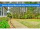 Lush backyard features a serene, fenced perimeter surrounded by trees, shrubs and flourishing landscaping at 2935 Moss Bridge Ln., Myrtle Beach, SC 29579