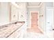 Bathroom featuring granite countertops, a framed mirror, and entry to an organized walk-in closet at 2935 Moss Bridge Ln., Myrtle Beach, SC 29579