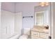 Cozy bathroom featuring a vanity with stone countertop, a commode, and a tub-shower combo at 2935 Moss Bridge Ln., Myrtle Beach, SC 29579