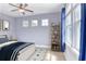Bright bedroom with decorative touches, including artwork and shelving, complemented by soft natural light at 2935 Moss Bridge Ln., Myrtle Beach, SC 29579