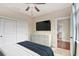 Neutral bedroom with television, dresser and an ensuite bathroom provides a relaxing and private space at 2935 Moss Bridge Ln., Myrtle Beach, SC 29579