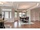 Elegant dining room with hardwood floors, decorative chandelier, and large windows for natural light at 2935 Moss Bridge Ln., Myrtle Beach, SC 29579