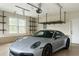 Spacious garage featuring storage shelves and a parked luxury silver sports car at 2935 Moss Bridge Ln., Myrtle Beach, SC 29579