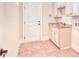 Functional laundry room with sink, granite countertops, cabinets, and exterior door at 2935 Moss Bridge Ln., Myrtle Beach, SC 29579
