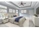 Serene main bedroom with a tray ceiling, soft color palette, a ceiling fan, and large windows at 2935 Moss Bridge Ln., Myrtle Beach, SC 29579